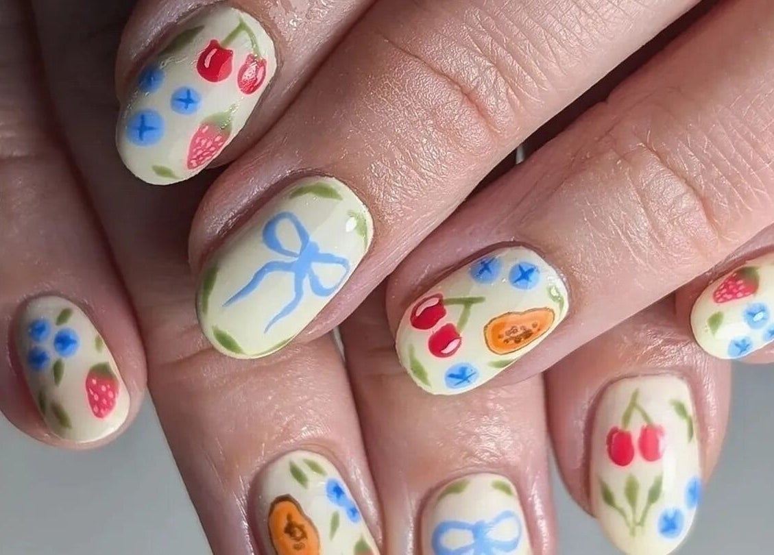 Vibrant floral nail art at Sun Day Studio, Truro, England, GB, showcasing detailed fruit and flower designs.