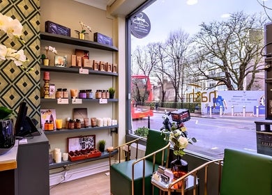 Elegant interior of Mr M’s in London, England, GB showcasing beauty products and street view.