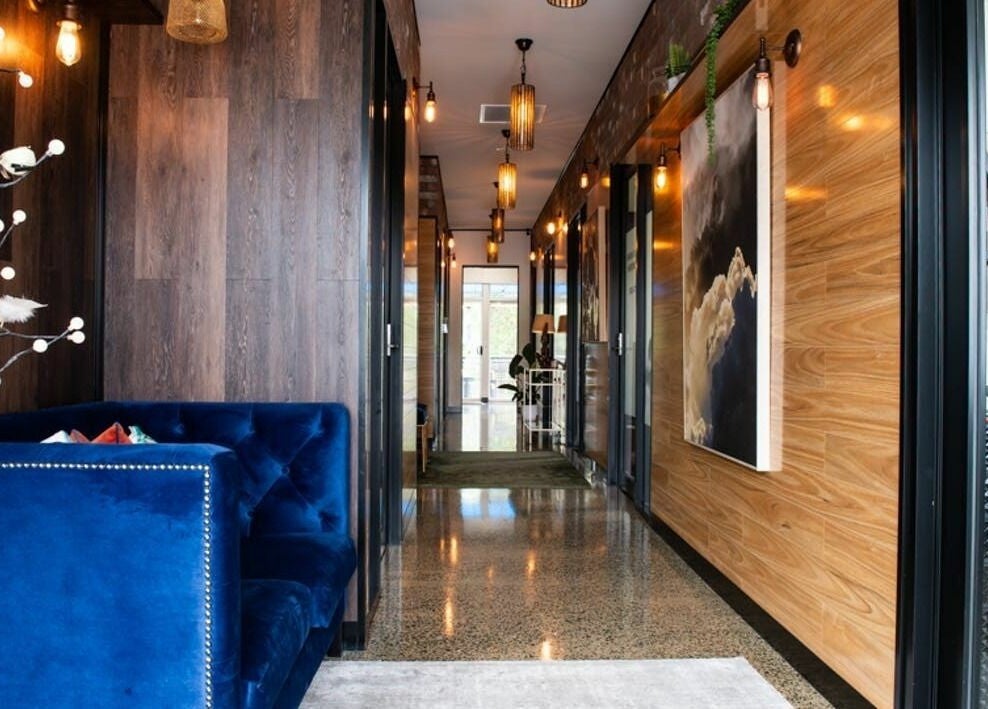 Elegant hallway at RC Designs, Paddington, Queensland, AU, with plush seating and ambient lighting.
