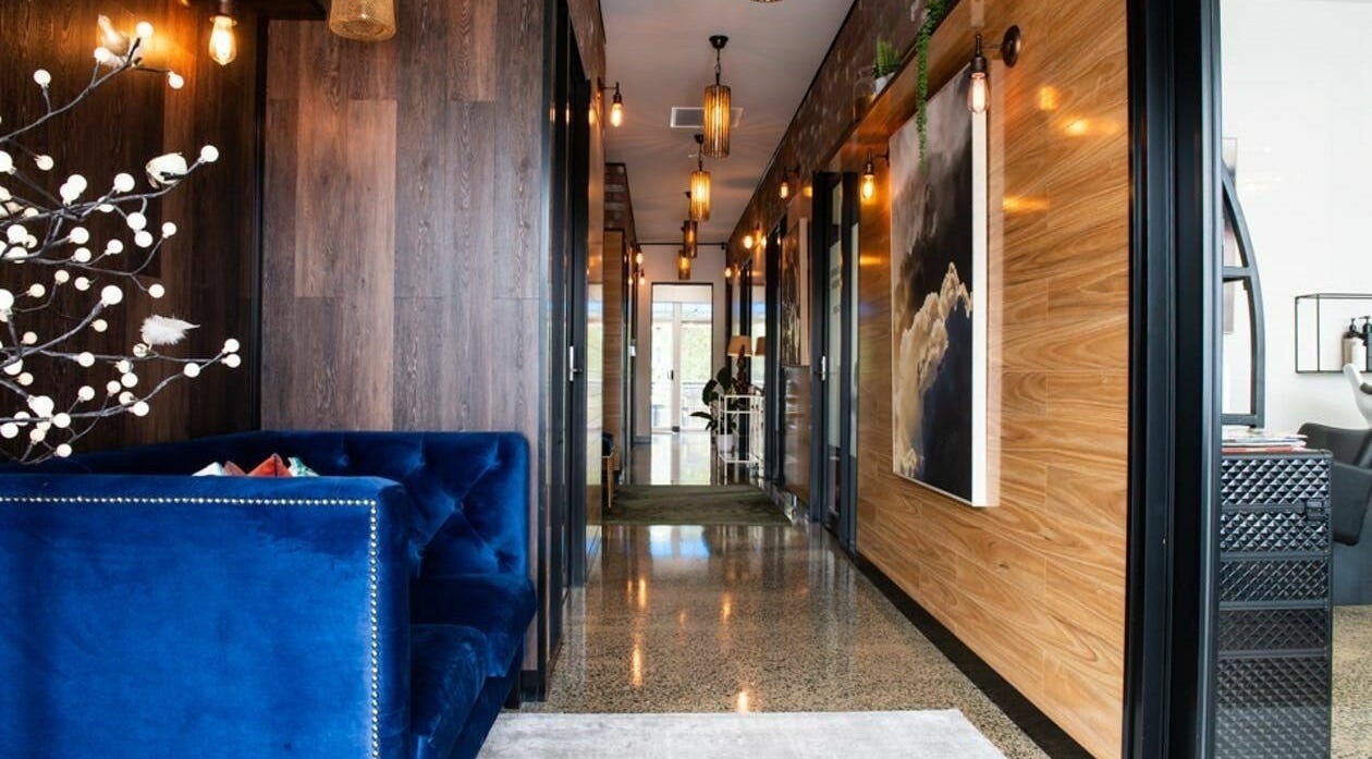 Elegant hallway at RC Designs, Paddington, Queensland, AU, with plush seating and ambient lighting.