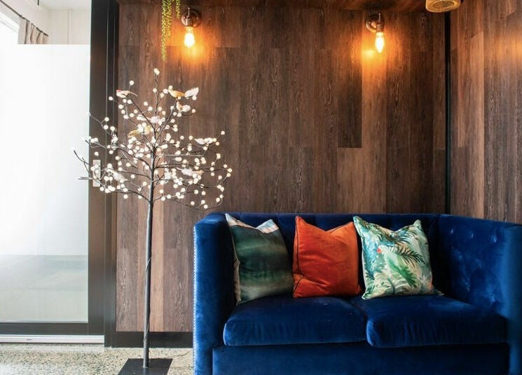 Stylish lounge at RC Designs, Paddington, Queensland, AU with a velvet sofa and decorative lighting.