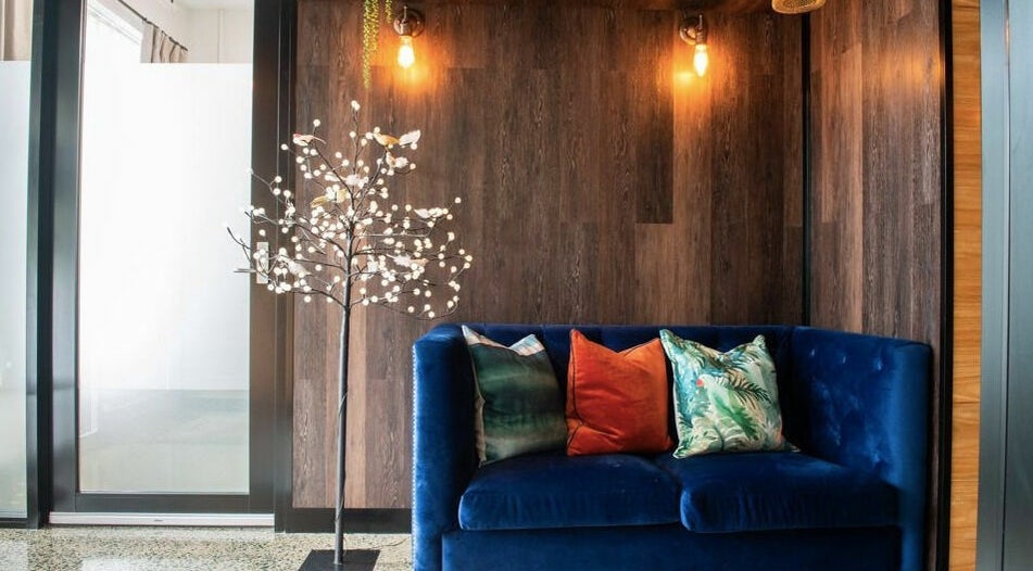 Stylish lounge at RC Designs, Paddington, Queensland, AU with a velvet sofa and decorative lighting.