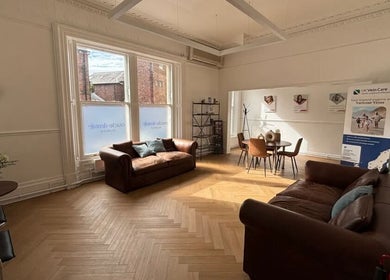 Inviting lounge at CL Body Therapy, Carlisle, England, GB, featuring sofas and natural light.
