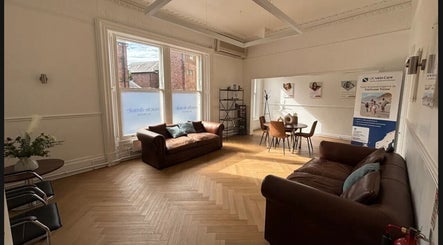 Inviting lounge at CL Body Therapy, Carlisle, England, GB, featuring sofas and natural light.