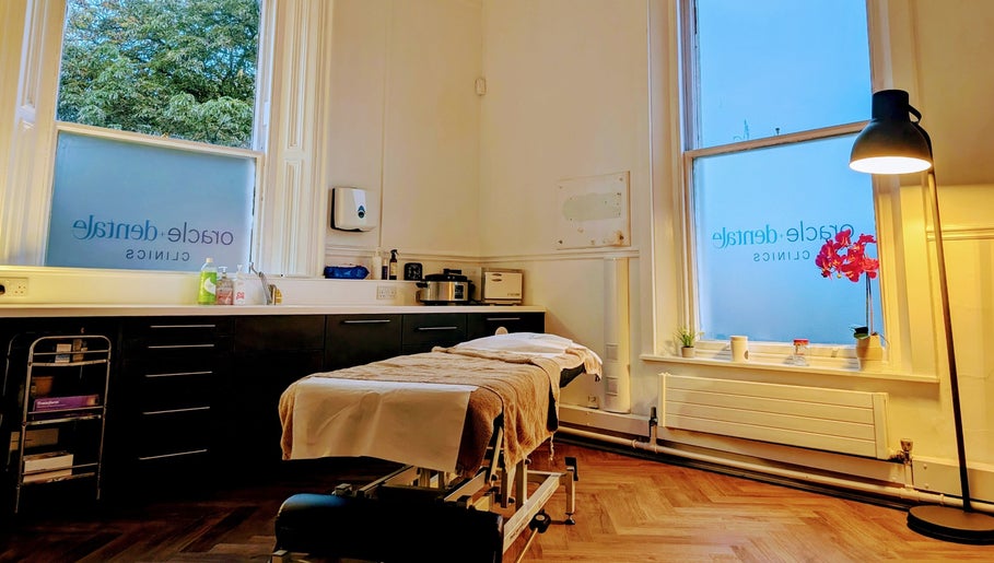 Serene treatment room at CL Body Therapy, Carlisle, England, GB with massage table and ambient lighting.