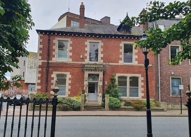 Exterior of CL Body Therapy in Carlisle, England, showcasing a vintage red-brick building.