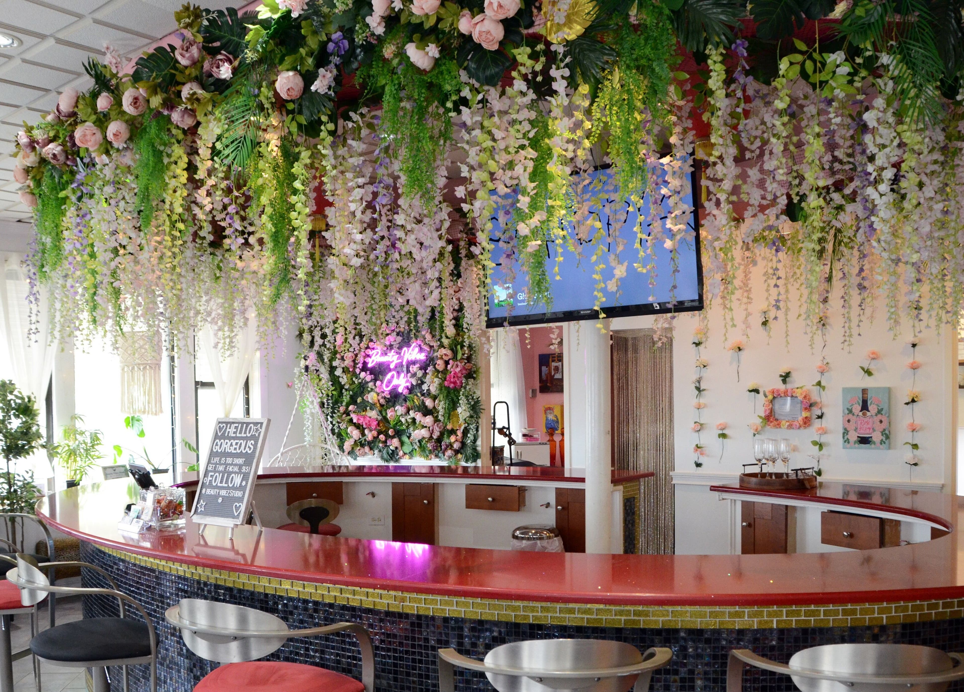 Lush floral decor at Beauty Vibez Studio, Chicago, Illinois, US with plush seating and vibrant, inviting space.