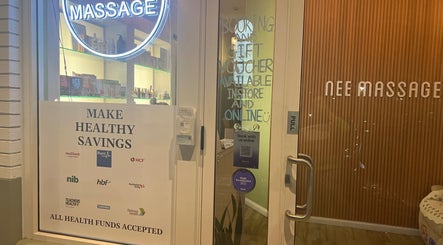 Entrance of Nee Massage | BICTON in Bicton, WA, AU with neon massage sign and health fund acceptance notice.