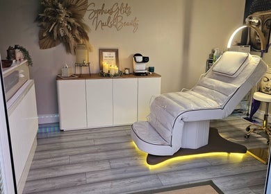 Cozy treatment room at Sophie's Glitz Nails & Beauty Salon, Attleborough, England, GB with plush reclining chair.