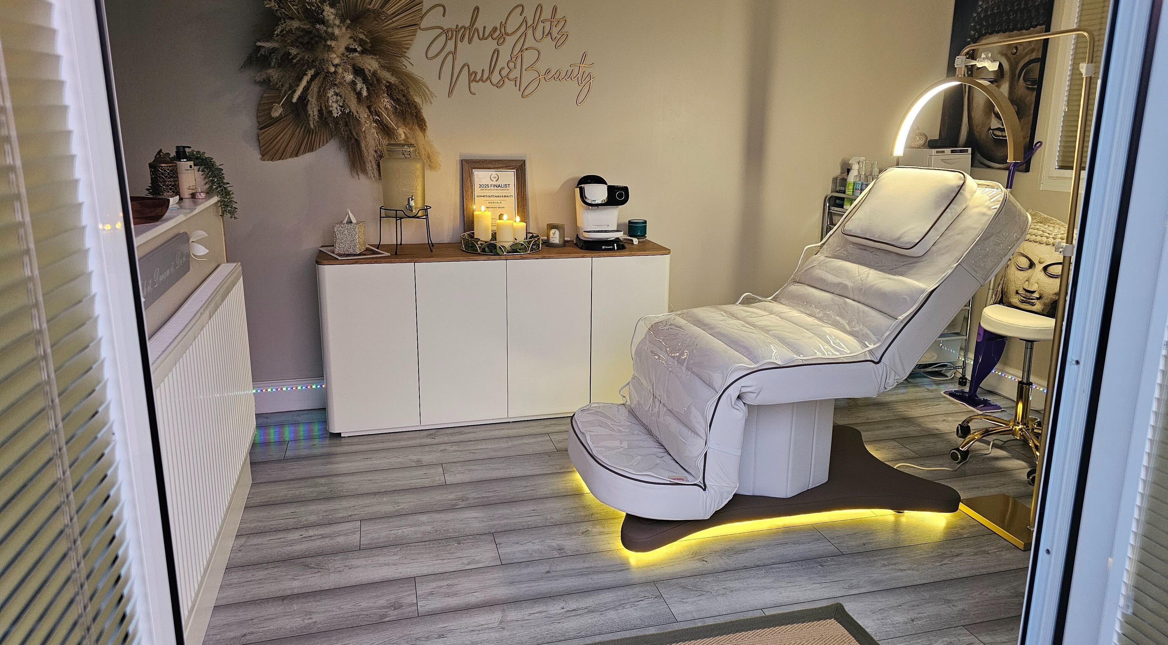 Cozy treatment room at Sophie's Glitz Nails & Beauty Salon, Attleborough, England, GB with plush reclining chair.