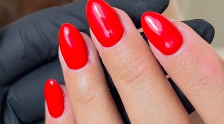 Close-up of glossy red nails at The Beauty Booth, Nantwich, England, GB.