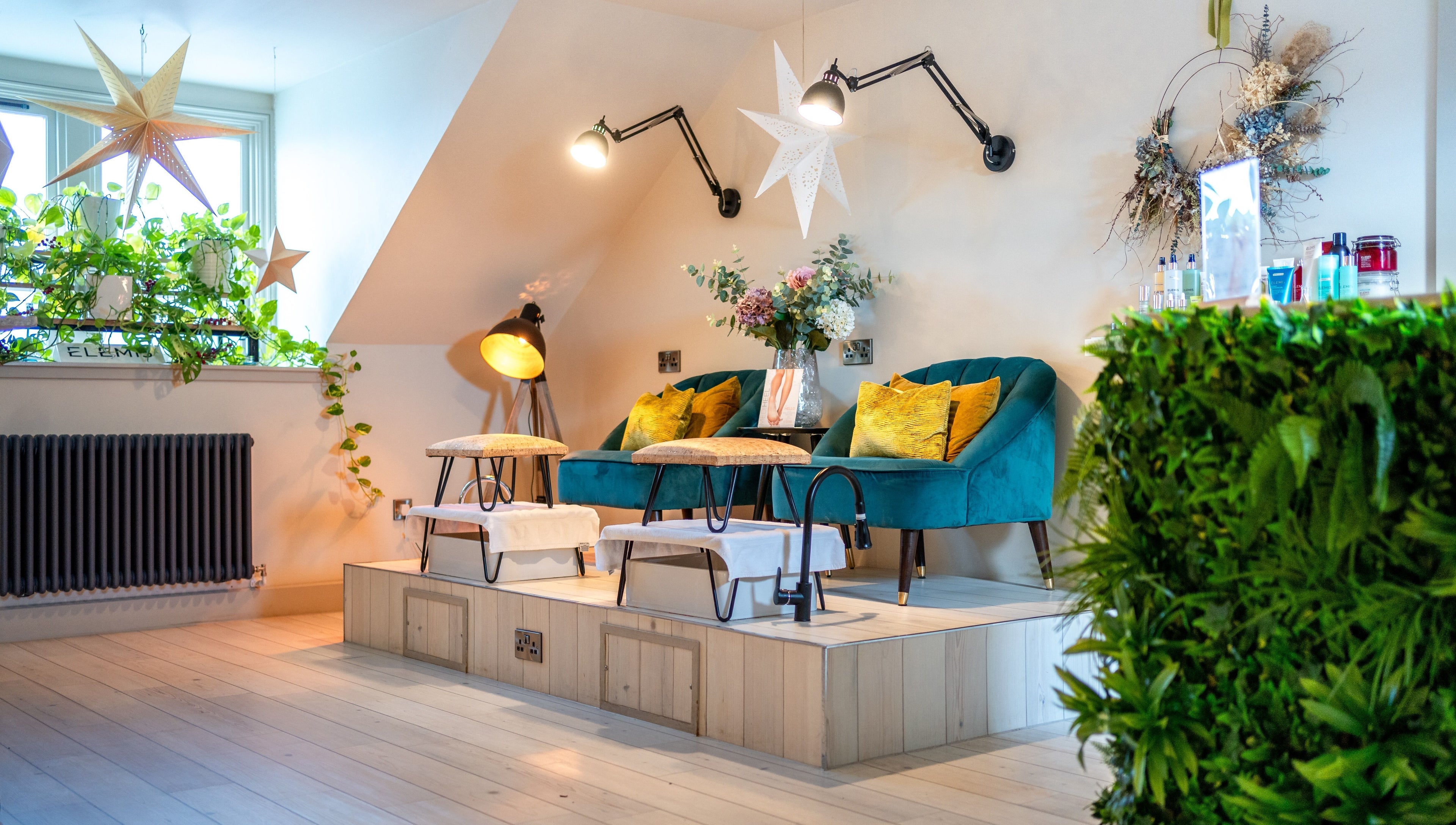 Chic seating area at Spa on the Hill in North Berwick, Scotland, GB with stylish decor and lush greenery.