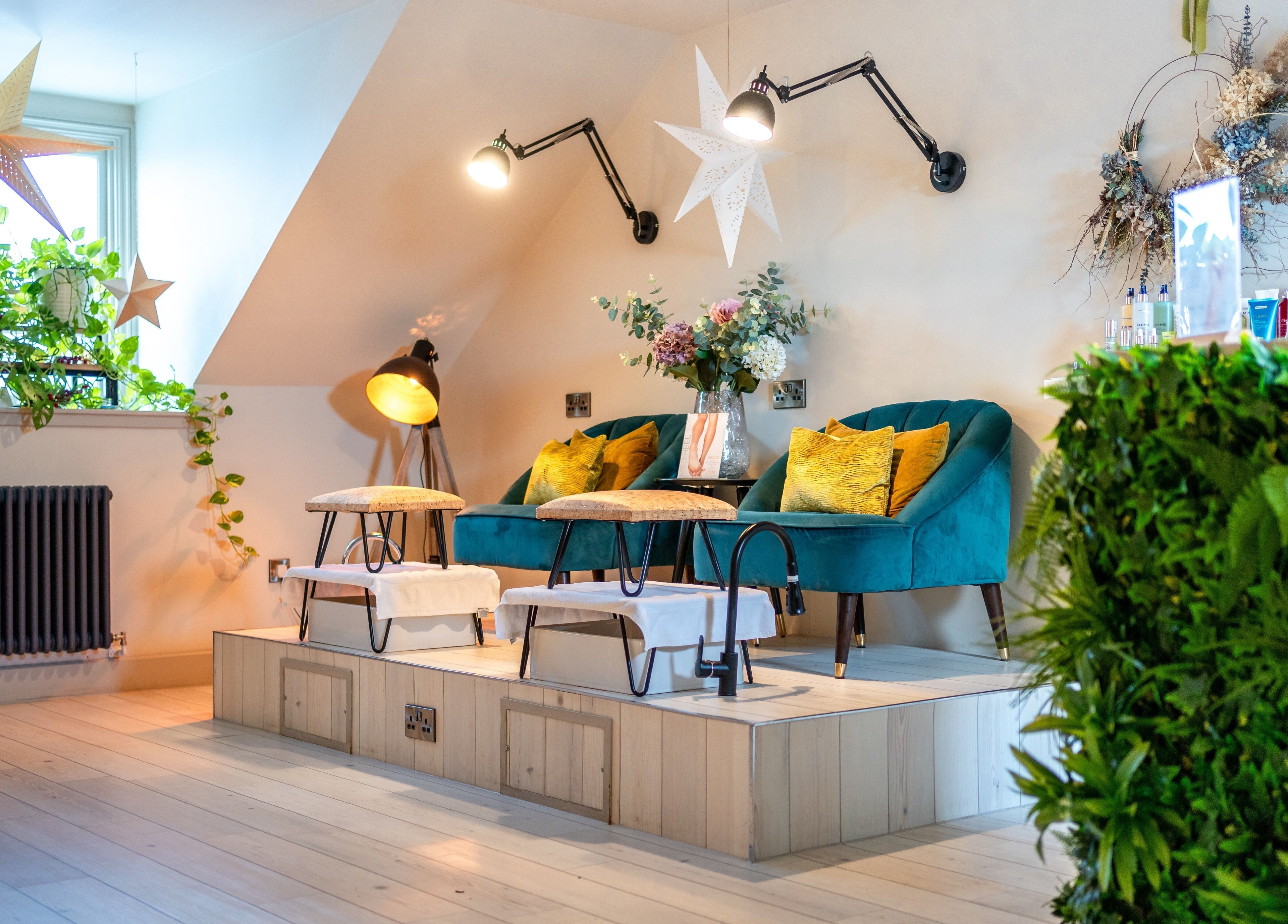 Chic seating area at Spa on the Hill in North Berwick, Scotland, GB with stylish decor and lush greenery.