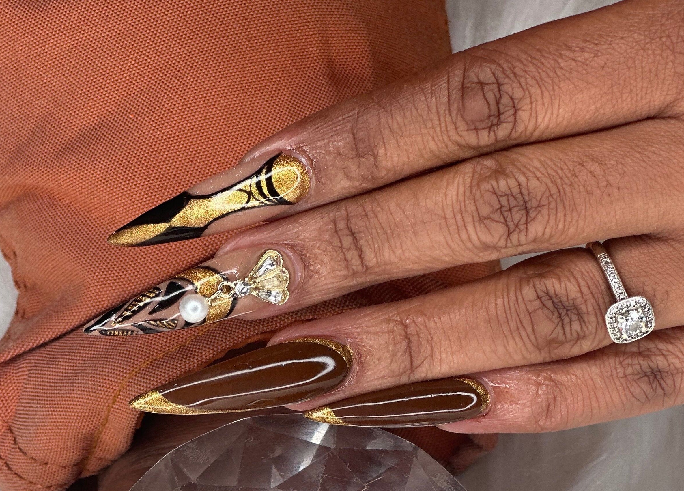 Intricate nail art with gold and pearl design at Elysian Escape Day Spa, Germiston, Gauteng, ZA.