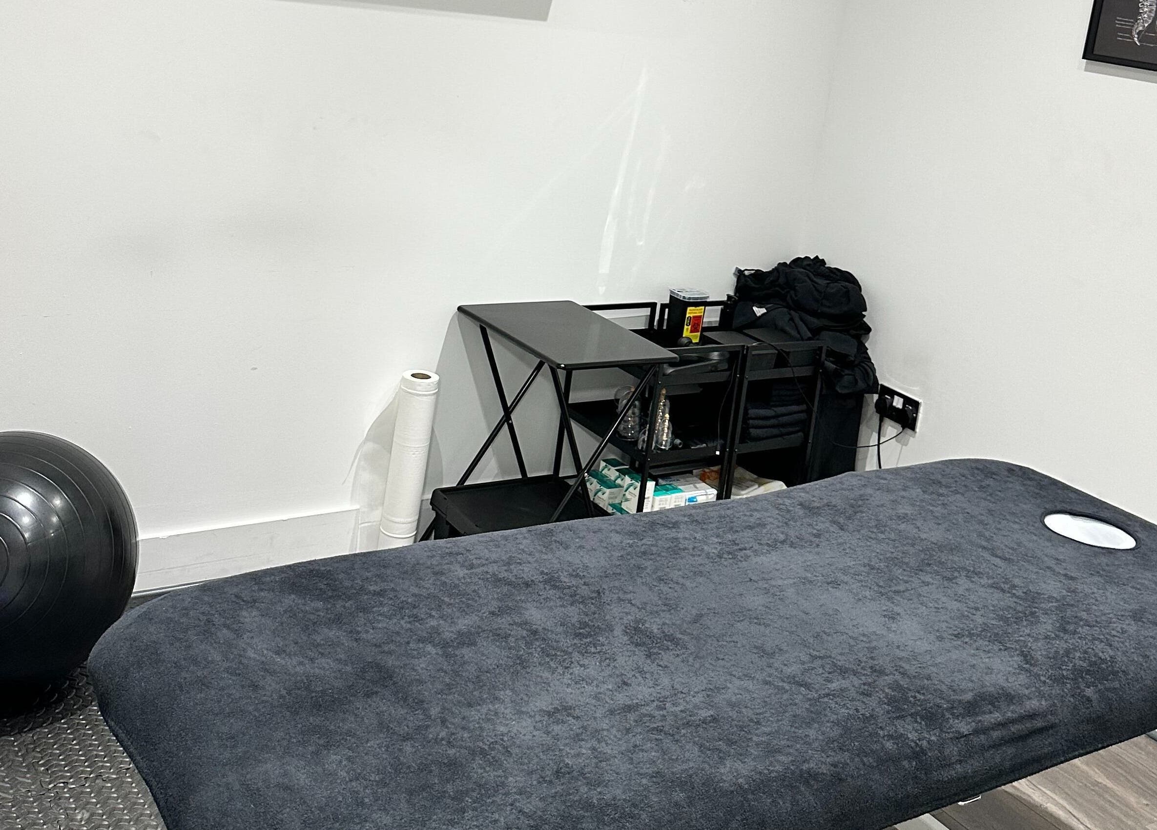 Therapy room at The Cryo Lab in Whitefield, England, GB with a massage table and exercise ball.