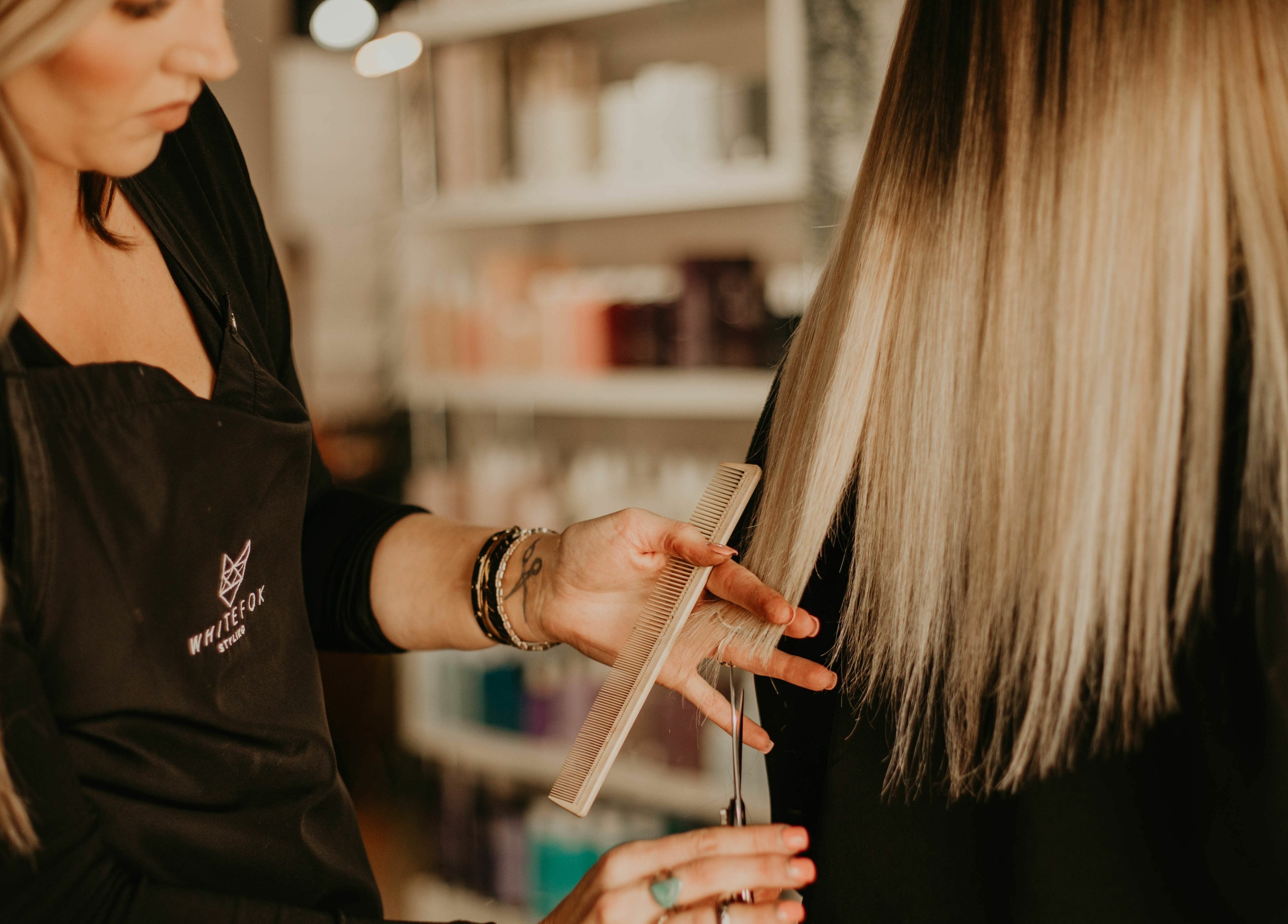 Professional hairstylist at Whitefox Styling, Amarillo, Texas crafting a chic haircut.