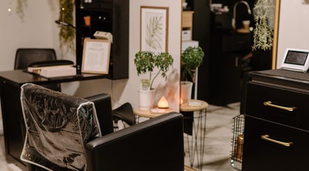 Elegant salon seating area at Mirrored by Melissa, Webster, New York, US, featuring sleek furniture and decor.