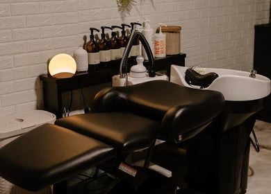 Relaxing salon corner at Mirrored by Melissa, Webster, New York, US with a modern hair wash station.