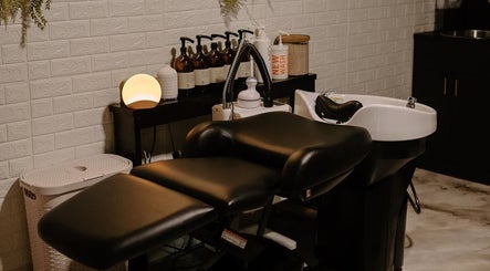Relaxing salon corner at Mirrored by Melissa, Webster, New York, US with a modern hair wash station.