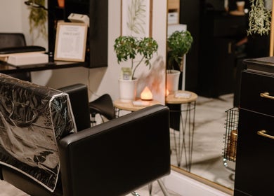 Modern salon chair and decor at Mirrored by Melissa, Webster, New York, US, offering a chic atmosphere.