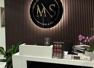 Reception desk at Lash and PMU Academy in Reading, England, GB with elegant decor and signage.