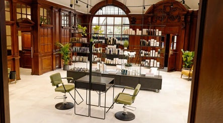 Luxurious interiors of Charlie Perry Skin, London, England, GB showcasing treatment area with rich wood decor.