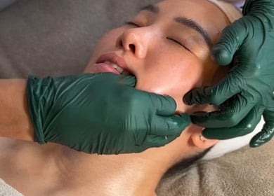Facial massage at Charlie Perry Skin, London, England, GB, promoting rejuvenation and relaxation.