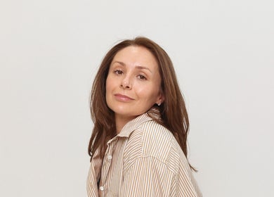 Woman with serene expression at Charlie Perry Skin, London, England, GB showing natural beauty care.