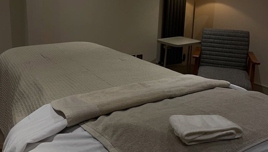 Cozy massage bed at Charlie Perry Skin, London, England, GB. Inviting wellness retreat with a calm ambiance.