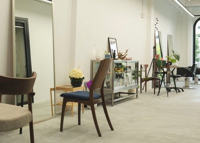Chic interior of SENTTEN. Japanese Hair Salon in Singapore, Singapore, SG, showcasing elegant wooden chairs.