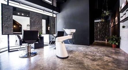 Modern interior of SENTTEN. Japanese Hair Salon in Singapore, SG, featuring stylish chairs and a sleek wash station.