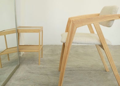 Modern wooden chair in SENTTEN. Japanese Hair Salon, Singapore, offering minimalist elegance.