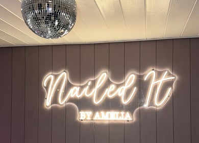 Neon sign of Nailed It by Amelia in Cheslyn Hay, England, GB under a sleek disco ball.