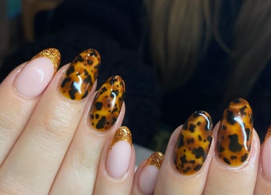 Leopard print nails with gold glitter tips at Nailed It by Amelia, Cheslyn Hay, England, GB.