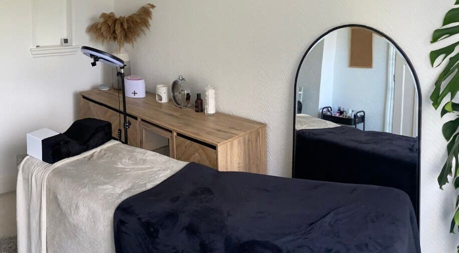 Cozy treatment room at Lashes & Brows By Lil, Hoddesdon, England, GB with modern decor and soft bedding.