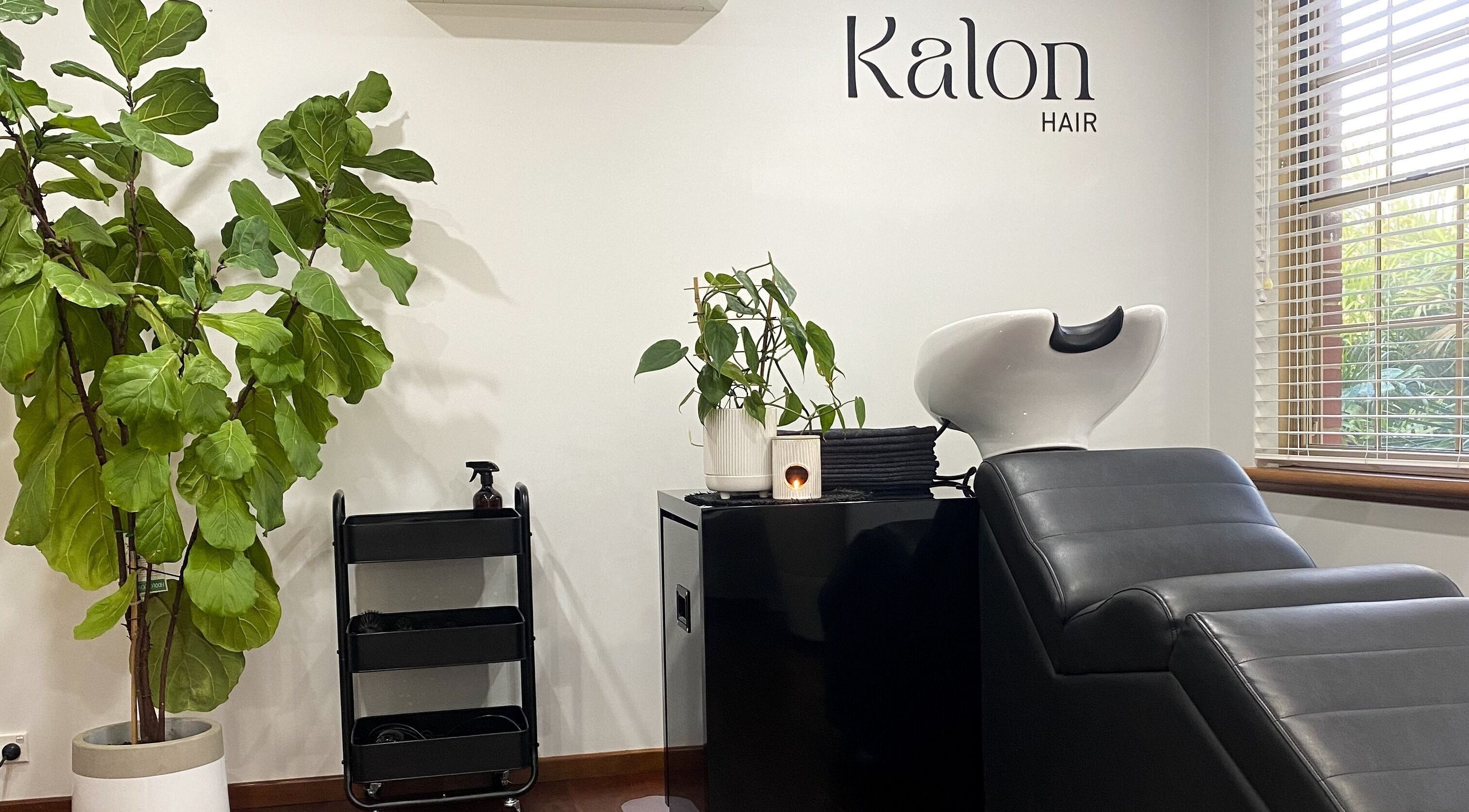 Relaxing hair wash station at Kalon Hair Perth, Perth, Western Australia, AU with lush greenery.