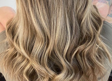 Elegant wavy blonde hairstyle at Kalon Hair Perth, located in Perth, Western Australia, AU.
