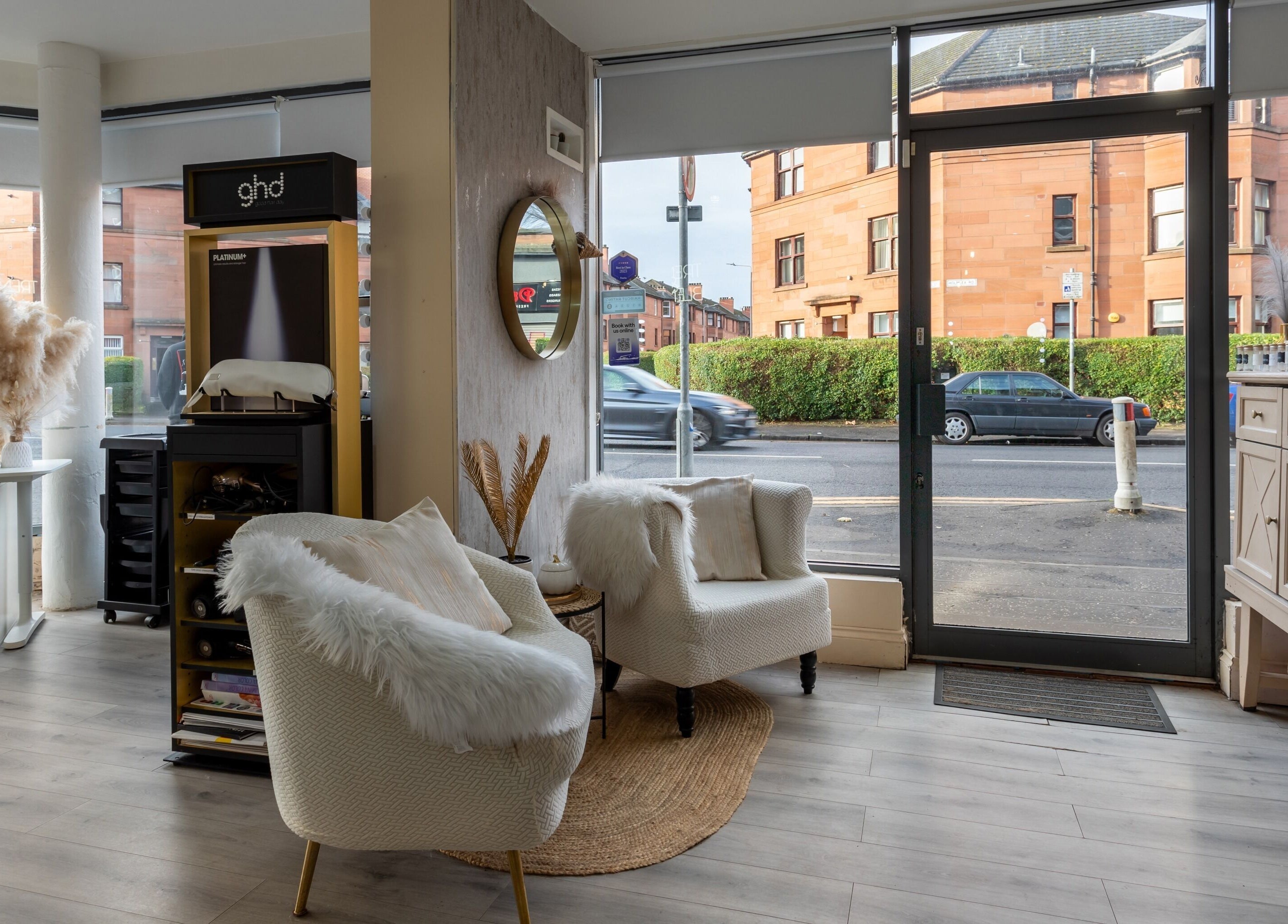 Inviting seating area inside BLOND Salon, Glasgow, Scotland, GB with stylish decor and large windows.