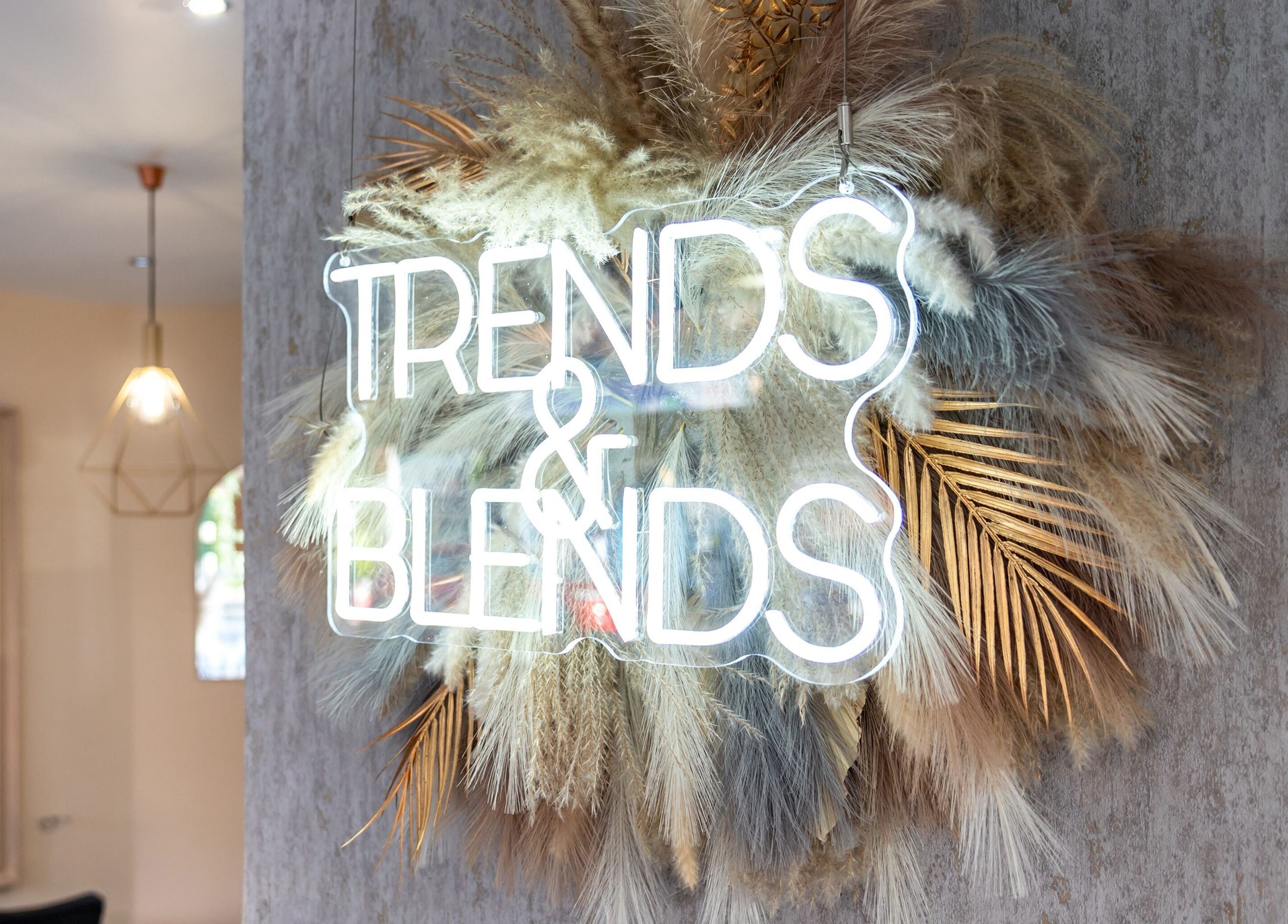 Neon sign 'Trends & Blends' inside BLOND Salon, Glasgow, Scotland, GB, with stylish decor.