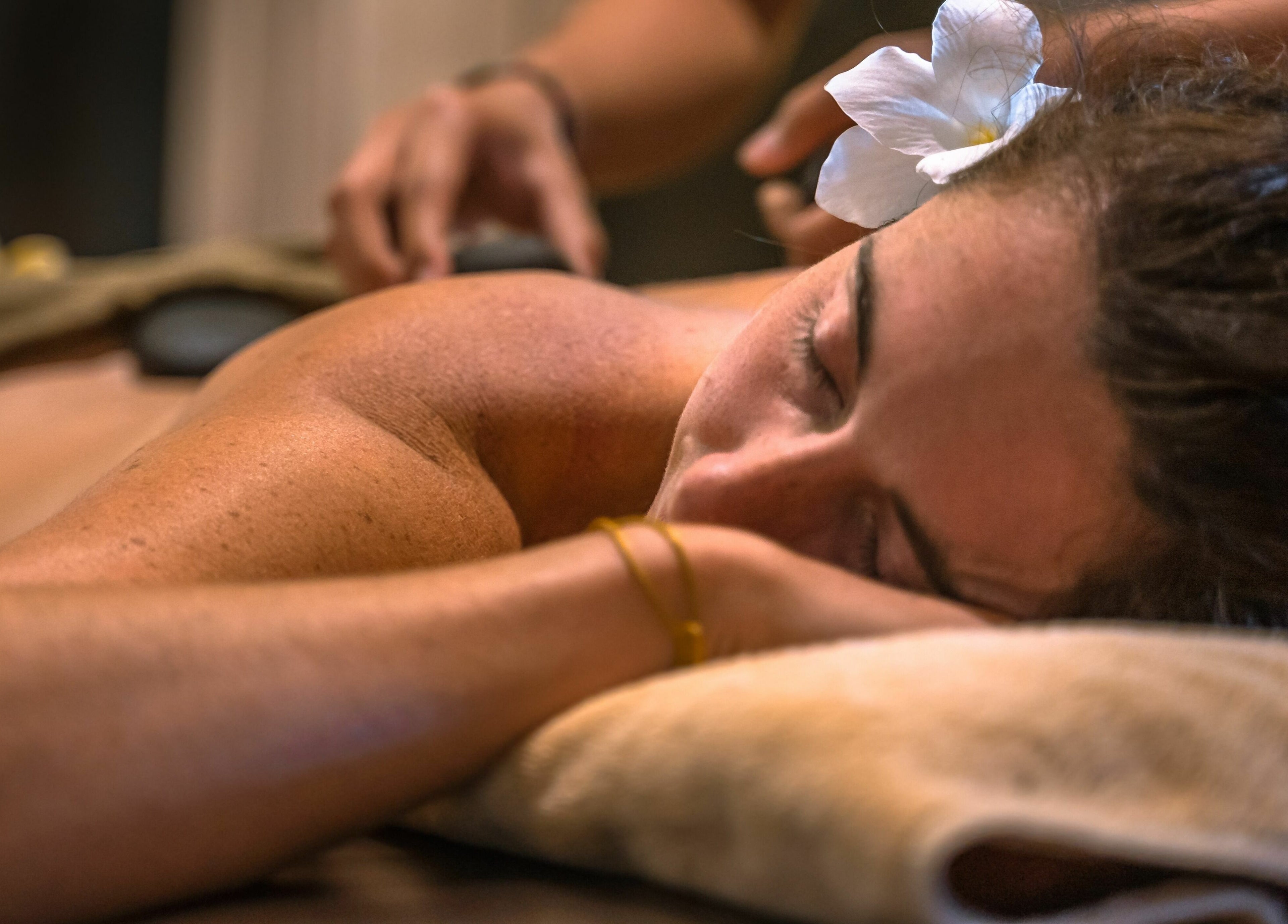 Relaxing massage at Laniakea Spa in Bali, Bali, ID, featuring soothing hot stones and peaceful ambiance.