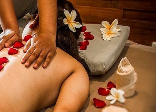 Relaxing massage at Laniakea Spa in Bali, Bali, ID with flower petals and soothing ambiance.