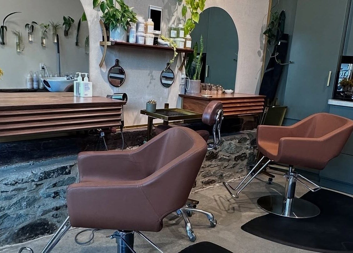 Cozy interior of Bellwether Salon in Boston, Massachusetts, US, featuring modern chairs and stylish decor.