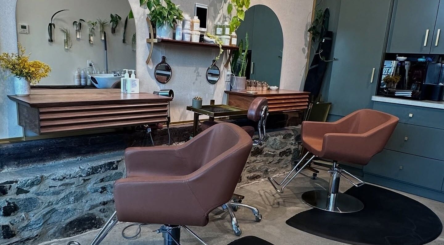 Cozy interior of Bellwether Salon in Boston, Massachusetts, US, featuring modern chairs and stylish decor.