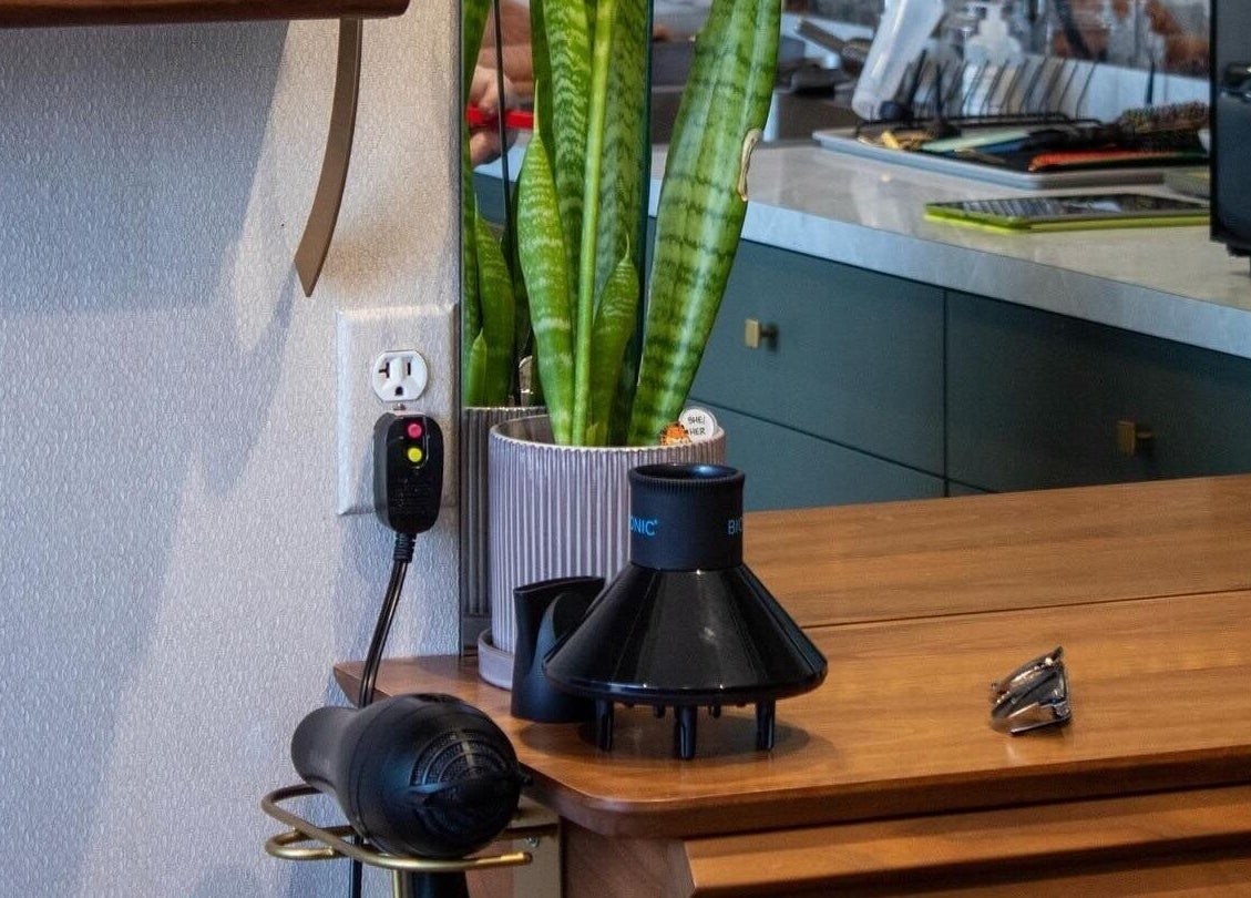 Modern setup at Bellwether Salon, Boston, Massachusetts with styling tools and lush plant decor.