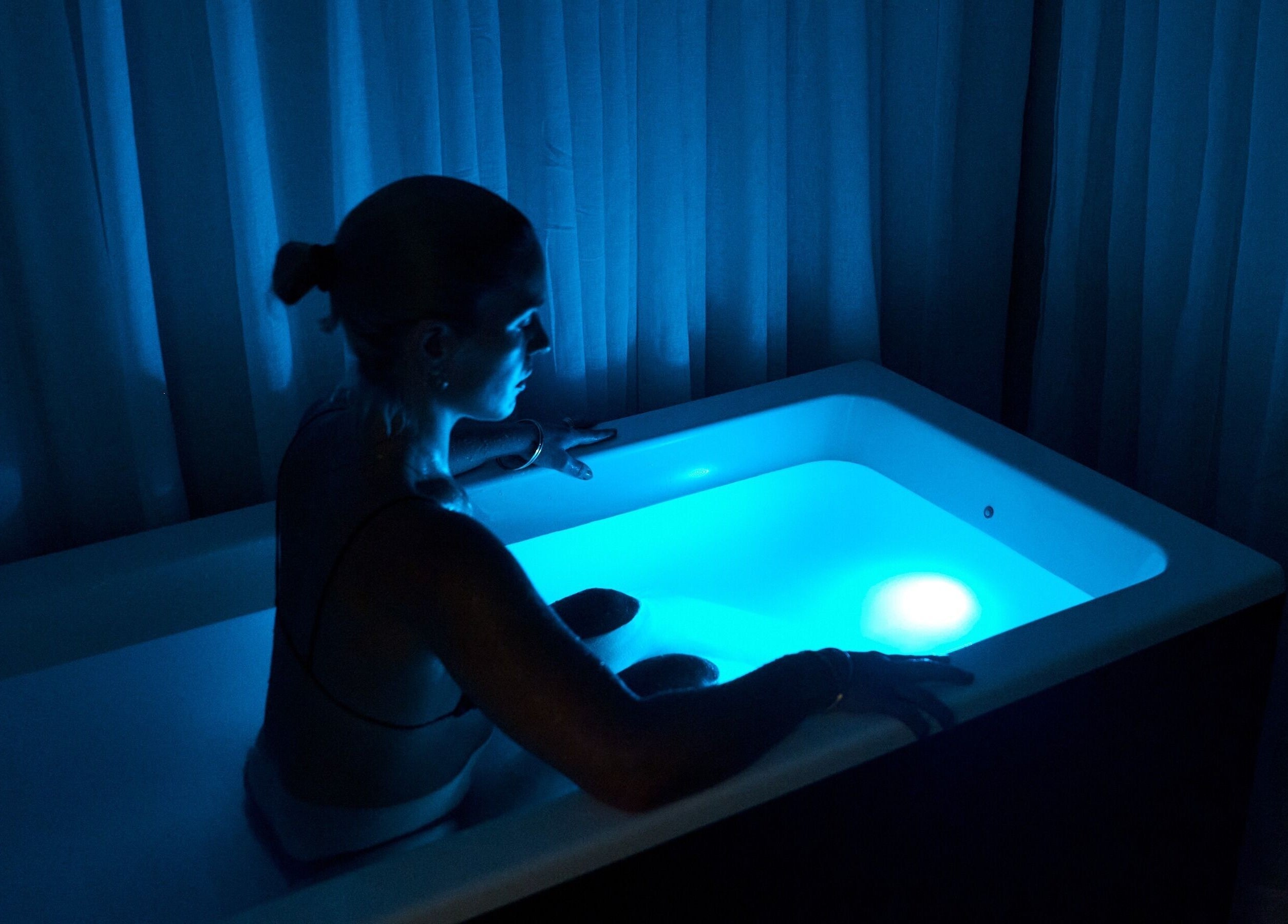 Person enjoys calming blue light soak at Nimbus Co Richmond, Richmond, Victoria, AU.