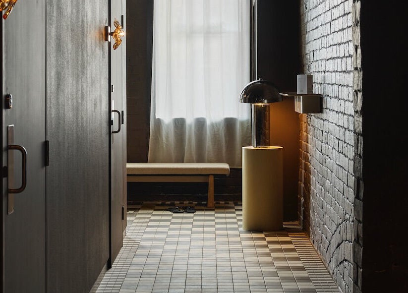 Calm corridor at Nimbus Co Fitzroy, Melbourne, Victoria, AU, featuring warm lighting and modern design.