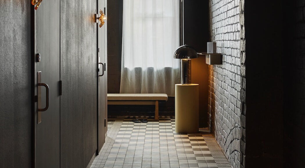 Calm corridor at Nimbus Co Fitzroy, Melbourne, Victoria, AU, featuring warm lighting and modern design.