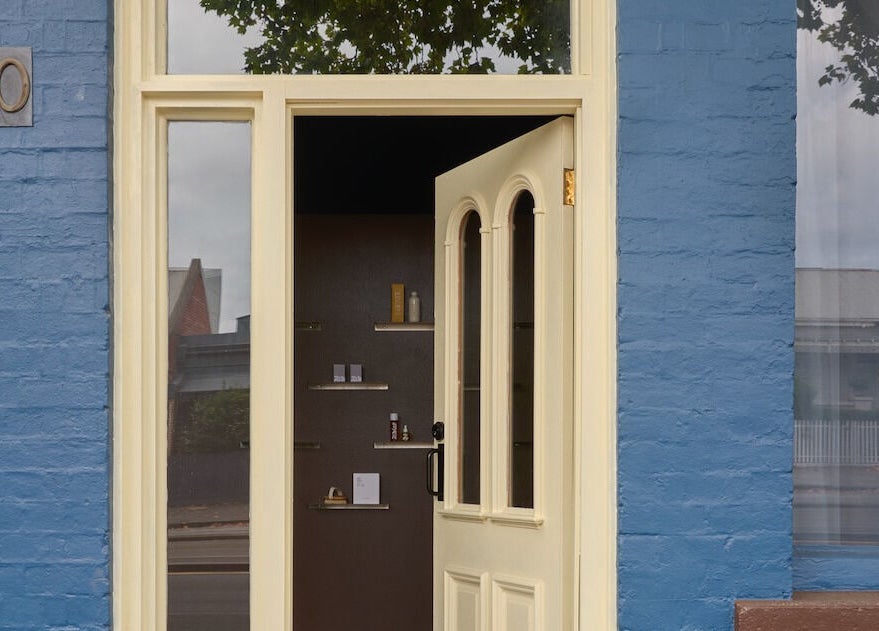Charming blue-brick entrance of Nimbus Co Fitzroy, Melbourne, Victoria, AU with an inviting open door.