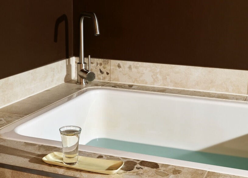 Elegant spa bath with glass at Nimbus Co Fitzroy, Melbourne, Victoria, AU, perfect for relaxation therapy.