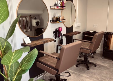 Modern salon interior at Rigs Wigs in Holywood, Northern Ireland, GB with stylish chairs and mirrors.